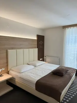 a bedroom with a large bed and a window at Hiša Aleš in Kranj