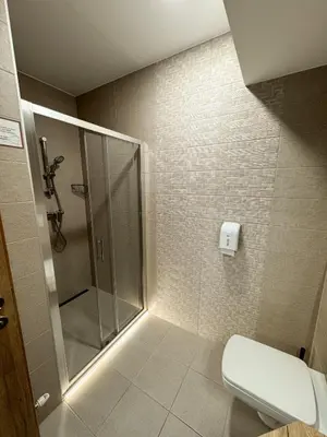 a bathroom with a shower and a white toilet at Hiša Aleš in Kranj