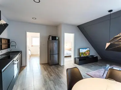 a kitchen and living room with a dining room at Flex Apartments Tour As Ljubljana in Ljubljana