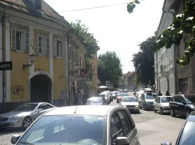 a busy city street with cars parked on the road at Flex Apartments Tour As Ljubljana in Ljubljana
