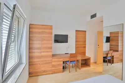 a dining room with a table and a tv at Prenočišča Kogoj in Miren
