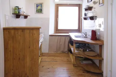 a kitchen with a wooden counter and a sink at Harmony Gallery in Ljubljana