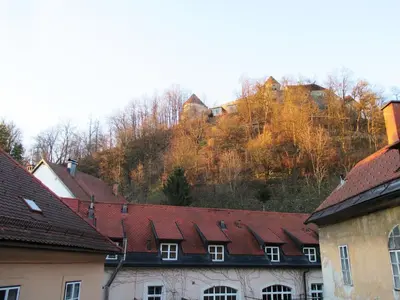 a group of buildings with red roofs and trees at Harmony Gallery in Ljubljana