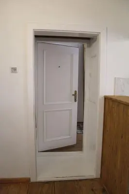 a white door with a mirror in a room at Harmony Gallery in Ljubljana