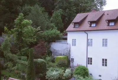 a white house with a garden in front of it at Harmony Gallery in Ljubljana