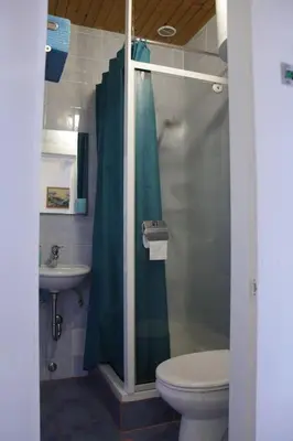 a bathroom with a shower and a toilet and a sink at Harmony Gallery in Ljubljana
