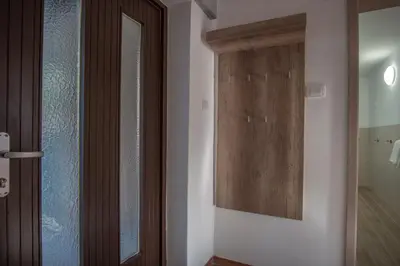 a room with a door and a mirror and a hallway at River View Apartment in Ljubljana