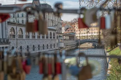 a view of a river with a bridge and buildings at River View Apartment in Ljubljana