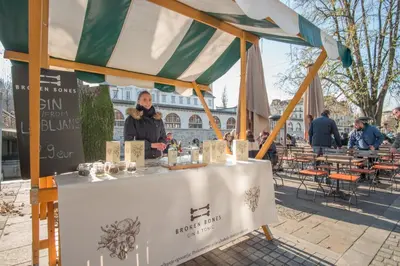 a woman standing at a table under a tent at River View Apartment in Ljubljana