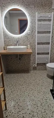 a bathroom with a sink and a mirror at Apartmajske hiške Lubadarček in Podčetrtek