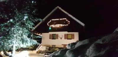 a house with a christmas sign and a christmas tree at APARTMENT CHALET -BOHINJ- Pokljuka- Triglav National Park in Koprivnik v Bohinju