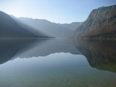 a large body of water with mountains in the background at APARTMENT CHALET -BOHINJ- Pokljuka- Triglav National Park in Koprivnik v Bohinju