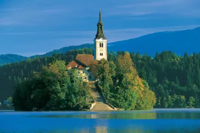a church on an island in the middle of a lake at APARTMENT CHALET -BOHINJ- Pokljuka- Triglav National Park in Koprivnik v Bohinju