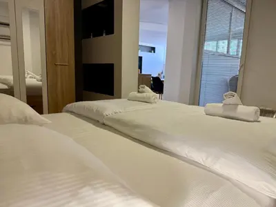three beds in a bedroom with towels on them at Apartments Park Šiška Ljubljana in Ljubljana