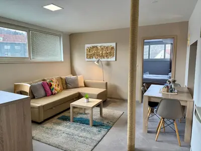 a living room with a couch and a table at Apartments Park Šiška Ljubljana in Ljubljana