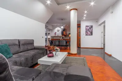 a living room with a couch and a table at Apartments Park Šiška Ljubljana in Ljubljana