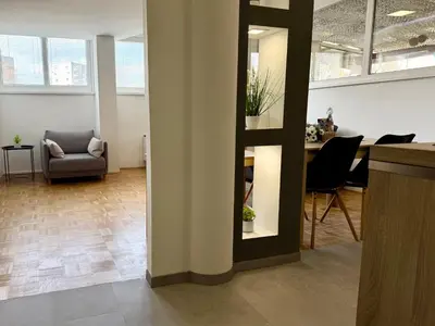 an office with a chair and a table in a room at Apartments Park Šiška Ljubljana in Ljubljana