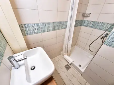 a bathroom with a toilet and a sink and a shower at B&B Pod Skalo in Kamnik