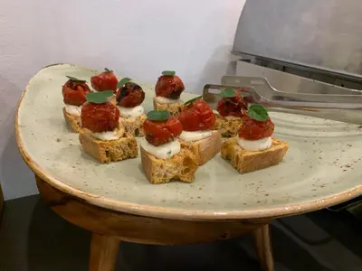a plate of food with bread with fruit on it at Hotel Sanje ob Soči ***/**** in Bovec