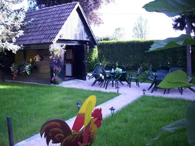a garden with chairs and a table and a house at Rooms4Young in Ljubljana