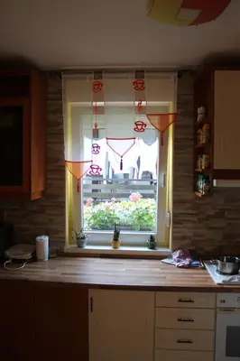 a kitchen with a window and a kitchen counter top at Rooms4Young in Ljubljana