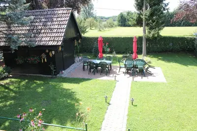 a patio with tables and chairs and red umbrellas at Rooms4Young in Ljubljana