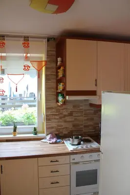a kitchen with a stove and a white refrigerator at Rooms4Young in Ljubljana