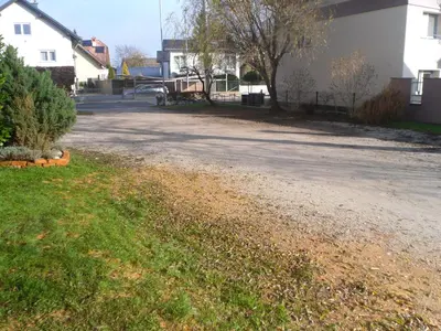 an empty road in a residential neighborhood with houses at Gostilna Ulčar in Ig