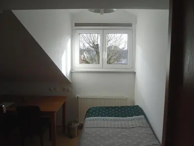 a small room with a desk and a window at Gostilna Ulčar in Ig