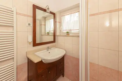 a bathroom with a sink and a mirror at Guest House Pod Slavnikom in Podgorje