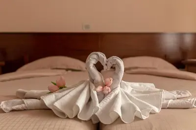 two swans made out of towels on a bed at Guest House Pod Slavnikom in Podgorje