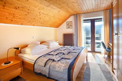 a bedroom with a bed with a wooden ceiling at Lake Bled Apartment Marjetka in Bled