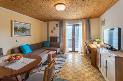 a living room with a couch and a table at Lake Bled Apartment Marjetka in Bled