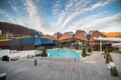 a large building with a swimming pool in front of it at Apartment Amy in Podčetrtek