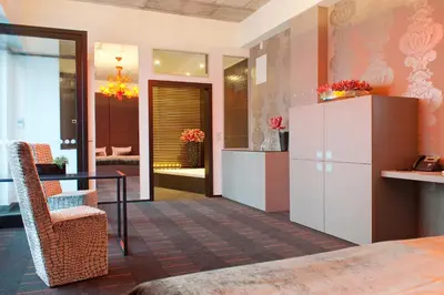 a lobby with a table and a chair at G Design Hotel in Ljubljana