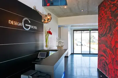 a lobby of a hotel with a desk and a sign at G Design Hotel in Ljubljana