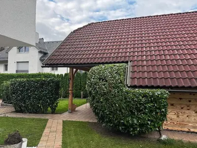 a roofed gazebo with a large letter e at Apartments Vila Cvetka Bled in Bled
