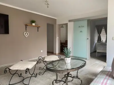 a living room with a glass table and a couch at Apartments Vila Cvetka Bled in Bled