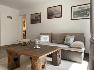 a living room with a couch and a wooden table at Apartments Vila Cvetka Bled in Bled