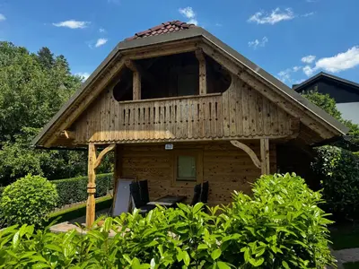a tree house with a deck on top of it at Apartments Vila Cvetka Bled in Bled