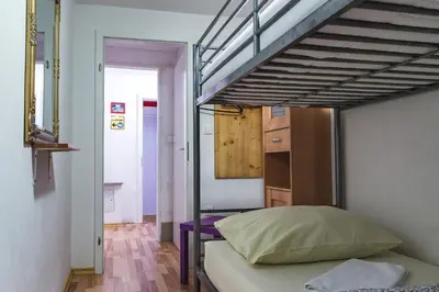 a small bedroom with a bunk bed and a bunk bed at Hostel 24 in Ljubljana