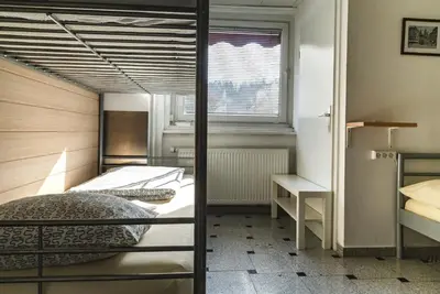 a bedroom with two bunk beds and a window at Hostel 24 in Ljubljana