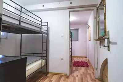 a room with a bunk bed and a hallway at Hostel 24 in Ljubljana