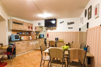 a kitchen and dining room with a table and chairs at Hostel 24 in Ljubljana