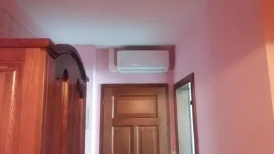 a room with a door and a ceiling with a ceiling fan at Merkež Guest House in Bizeljsko