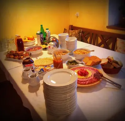 a table with plates and other food on it at Merkež Guest House in Bizeljsko