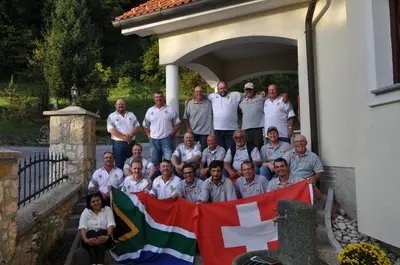 a group of people posing for a picture with a flag at Grobelnik Tourist Farm in Sevnica