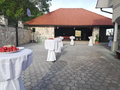 a row of tables with white table cloths at Grobelnik Tourist Farm in Sevnica