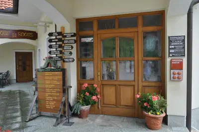 a door of a building with flowers in front of it at Grobelnik Tourist Farm in Sevnica