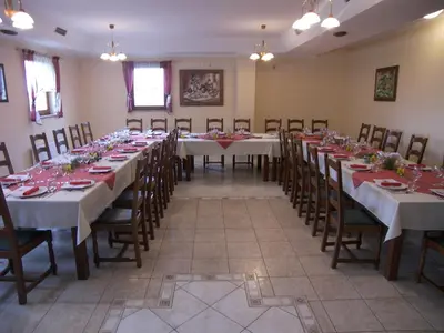 a large room with long tables and chairs at Grobelnik Tourist Farm in Sevnica